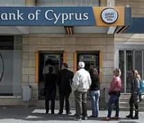 Cyprus reopens banks under tight restrictions