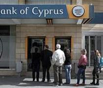 Cyprus reopens banks under tight restrictions