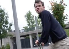 What is Carlsen doing on a bike at Chess Olympiad?