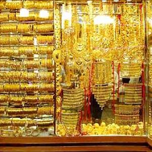 Gold price inches up, silver falls