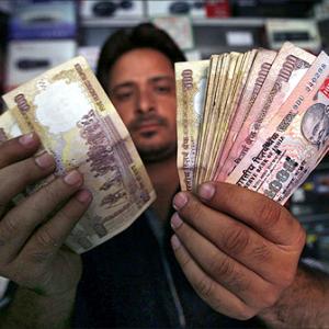 Rupee up 13 paise to 67.13 in late morning deals