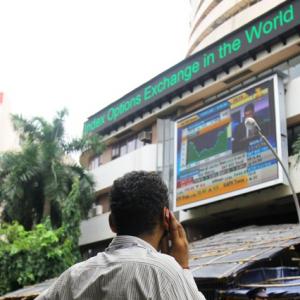 Markets end tad higher led by banks; metals falter