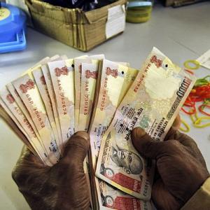 Rupee pares early gains, slips 6 paise vs $to 67.21