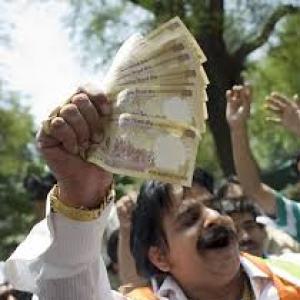 Rupee ends lower as dollar demand offsets shares recovery