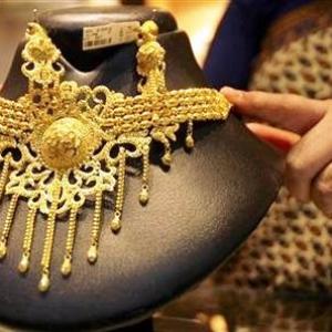 Gold falls on low demand; silver rises on global cues
