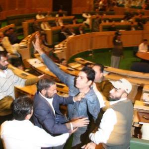 PIX: Three youth storm into the well of J&K assembly
