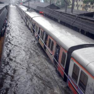 Photos: Heavy rains hit train services, make Mumbai crawl