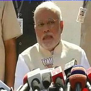 Modi in trouble with EC for flashing BJP symbol during presser