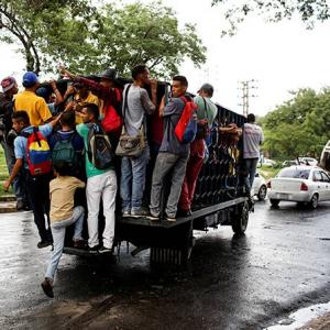 PHOTOS: Why Venezuelans are commuting on cargo trucks