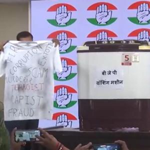 Displaying washing machine, Cong taunts BJP over clean chit to Praful Patel