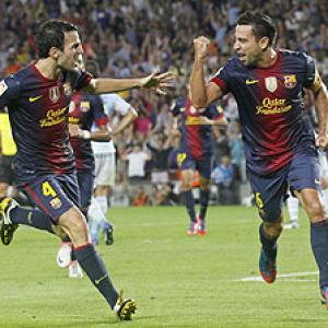 La Liga: Xavi, Messi score late to help Barca stay on top