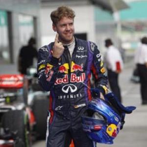 Vettel secures pole at rain-hit Sepang