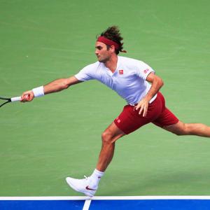US Open PIX: Federer, Djokovic advance; Wozniacki crashes out