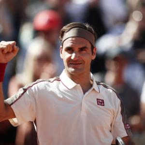 Federer earns milestone; Nadal powers past Goffin