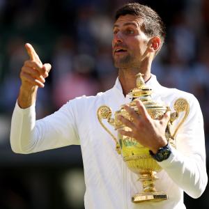 SEE: George Holds Djokovic's Trophy