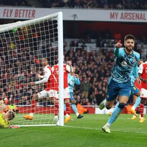PICS: Arsenal stage late escape, but title hopes hit