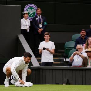 Wimbledon: Djokovic wipes slippery centre court