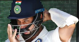 Why does Pujara usually not respond to criticism
