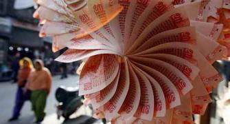 Rupee gains 14 paise against dollar