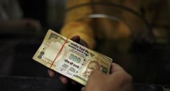 Rajan to ensure loan rates fall, cautions 'turbulent waters' ahead