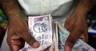 Rupee rises from record low, zooms 225 paise