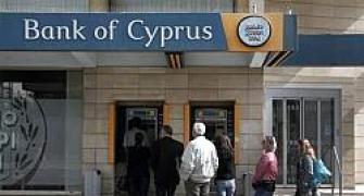 Cyprus reopens banks under tight restrictions