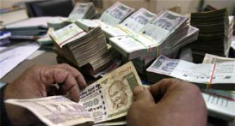 Rupee trims initial gains, still up by 14 paise vs dollar