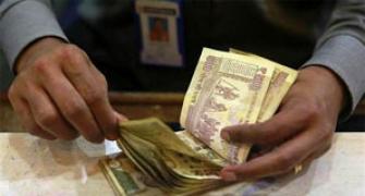 Rupee dips as shares remain under pressure