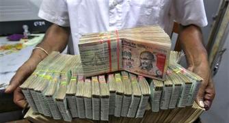 Rupee trims initial gains, still up 8 paise