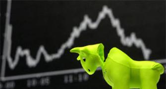 Markets trading flat; realty and power shine, banks fall