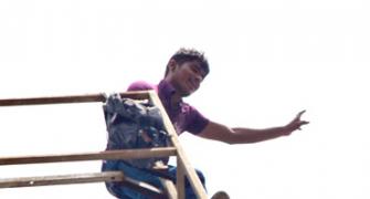 DRAMATIC PIX: Youth threatens suicide over Telangana