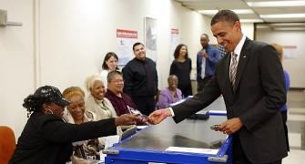 Obama flashes driving licence to cast historic vote