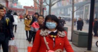 Smog chokes Beijing, clouds China's success story