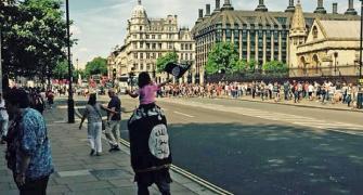 Man, child wave Islamic State flag outside UK Parliament