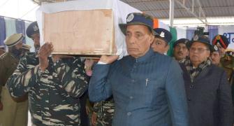 PIX: Rajnath helps carry coffin of slain CRPF jawan