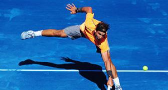 Federer rallies past Raonic, easy win for Nadal