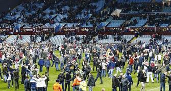 Villa charged following fans' pitch invasion