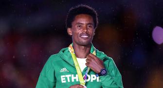 Ethiopian marathoner stays put in Rio, vows to fight for land rights