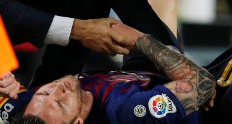 PHOTOS: Messi injury blow as Barca go top with win over Sevilla