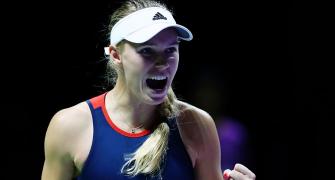 Wozniacki stays alive in Singapore; Federer survives scare