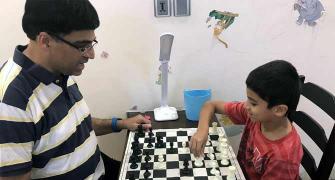 PIX: Anand celebrates International Chess Day with son