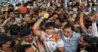 PIX: Frenzy, chaos as India's Olympics heroes return