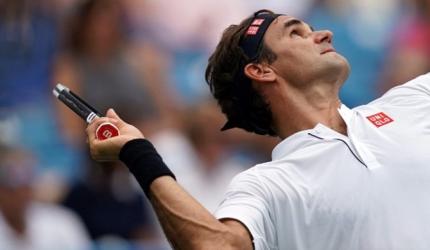 Federer wears down Wawrinka to maintain mastery over compatriot