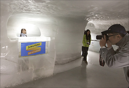 A tourist poses for a pictures in the Ice Palace glacier cave at the Jungfraujoch (altitude 3454 metres/11333 feet).