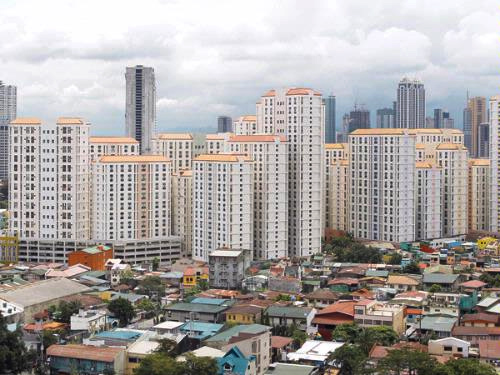 Rows of condominium buildings are seen behind a middle-class residential district in Mandaluyong, Metro Manila.