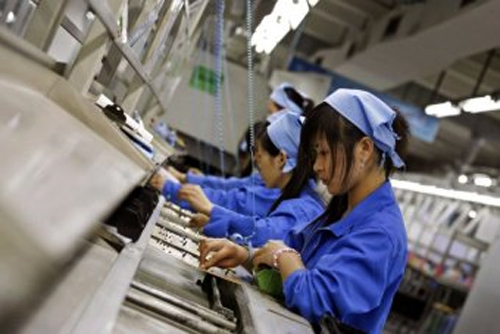 Workers assemble circuit boards at a production line in China's southern city of Shenzhen.