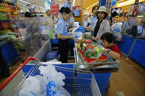 Customers check out at a super market in Ho Chi Minh city.
