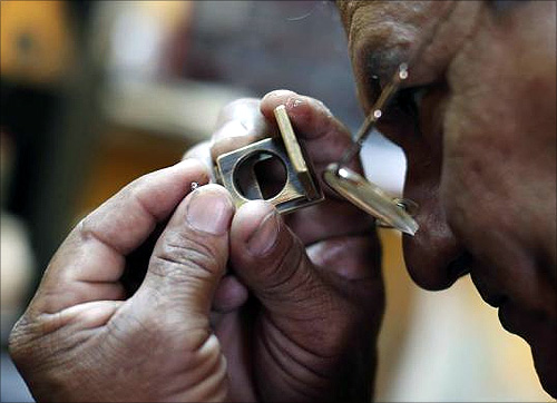 A diamond cutter inspects a rough stone in his work place in Santa Elena de Uairen in the south of Venezuela.