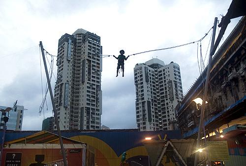 A boy plays on a giant trampoline at a mall in Mumbai.