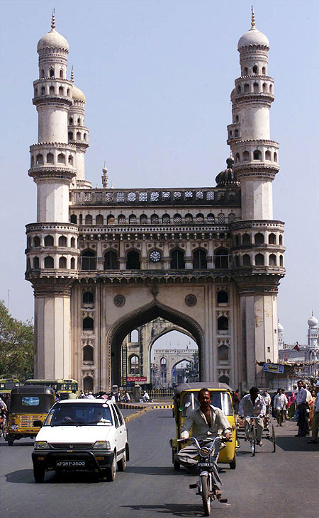 Residents of Hyderabad drive past the 'Charminar', the city's best known monument.